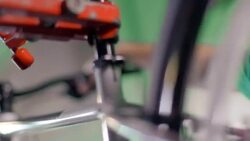 Bike mechanic inspects spinning wheel and squeezes brake lever on bicycle handlebar in repair shop Stock Footage