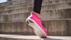 Young female athlete running up the stairs Stock Footage