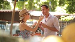 Young couple sample fruit in sunny Brazilian market Stock Footage