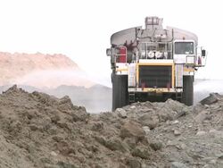WS Truck wetting road to suppress dust on mine road / Witbank, Northern Province, South Africa Stock Footage