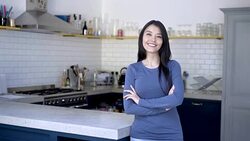 Real estate agent at a property standing and looking at the camera smiling Stock Footage