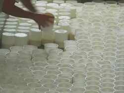 Cheesemaker Turning the Ricotta Moulds Stock Footage