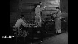 1946: REPRISING REACTION: EXT Chicago University. Physicist Enrico Fermi w/ assistant pulling cadmium-plated rod out of reactor CU Interpolation machine w/ light buttons flashing fast first atomic pile (Self-sustaining controlled nuclear reaction) Instructional Video