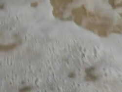 Footprint made in sand then washed away by wave Stock Footage