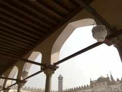 Wide Shot, tilt-down - Buildings with columns and arches surround a square in Egypt Stock Footage