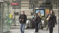 A young woman hands out pamphlets to commuters as they exit a metro station. Stock Footage