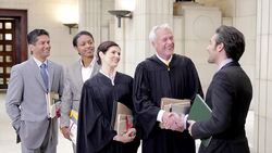 Judges and lawyers greeting in courthouse Stock Footage