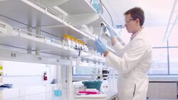 MS R/F Scientist in research laboratory filling test tubes with pipette and placing them in container of ice Stock Footage