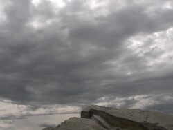 Business man reaches top of mountain Stock Footage