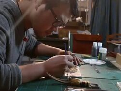 leatherworker paint  fish pattern on leather Stock Footage