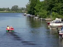 WS View of people enjoying their boat ferry from canal and other boats on harbor, North Sea North Frisia / Friedrichstadt, Schleswig Holstein, Germany Stock Footage