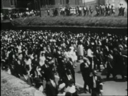 Mourners march down the street with the Rev. Martin Luther King, Jr.'s casket during his funeral procession. News Clip