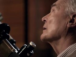 Old man with telescope Stock Footage