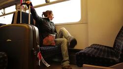 Solo Woman Traveler on Train with Luggage Stock Footage