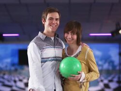 young couple holding bowling balls at a bowling alley Stock Footage