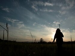 HD - Woman Walking into Sunset with Rifle Stock Footage