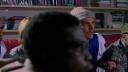 Group of young adult males on edge of seat watching sports on TV Stock Footage