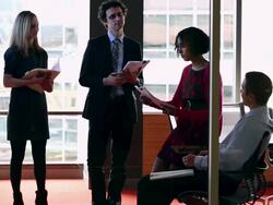 MS  Group of coworkers in discussion smiling and laughing in conference room while looking at chart on monitor/Washington, USA Stock Footage