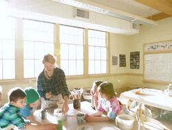 Students and teacher discuss cup in pottery class Stock Footage