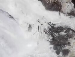 logs piled up at waterfall Stock Footage