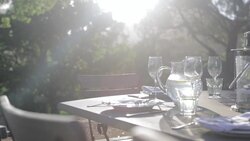 Sunbeam on table with luxury place settings in backyard Stock Footage