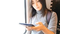 Woman use social media for communication in the sky train Stock Footage