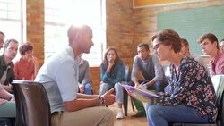 Woman taking notes in group therapy session Stock Footage