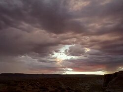 WS T/L Clouds moving across sky above desert below at sunset / Page, Neveda, United State Stock Footage