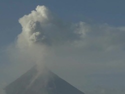 Volcano erupts large ash cloud into clear blue sky, Philippines, Dec 2009 Stock Footage