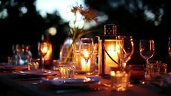 Table with luxury place settings in backyard at night Stock Footage