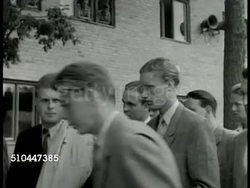 1949: SWEDEN ARMY TRAINING: EXT WS Swedish soldier leading recruits, walking. MS Recruits waiting. MS Recruits signing up at table. LA MS Recruits learning, practicing rifle drills. Instructional Video
