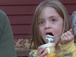 Little girl eating yogurt 720p30 Stock Footage