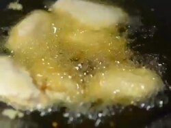 raw chickens are covered by flour in black pan Stock Footage