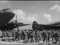 1953: FORMOSA, TAIWAN: MILITARY MANEUVERS: BEHIND Farmer & ox cart w/ baskets & potatoes, light tanks moving on road. VS Chinese Nationalist paratroopers preparing for practice jump, adjusting equipment, climbing steps of Kuomintang aircraft 6344. Instructional Video