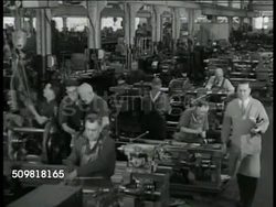 1944: JONES & LAMSON MACHINE COMPANY: EXT LA MS Sign. INT HA WS Factory workers at lathe machines. VS Workers operating lathe, machinery. MS 'Roll of Honor' plaque of names serving in Armed Forces. Springfield, Vermont Instructional Video