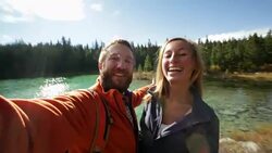 Young people hiking taking selfie portrait by the lake Stock Footage