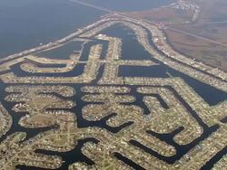 September 13, 2005 aerial wide shot zoom in over waterfront houses along Grand Lagoon / Slidell, Louisiana Stock Footage