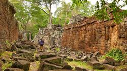 Young Woman Exploring Old Ruin of Angkor Temple in Cambodia Stock Footage