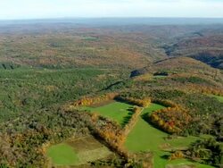 WS AERIAL View of wooded area and small lake with mountain range / Massachusetts, United States Stock Footage