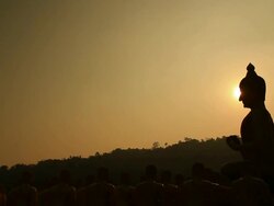 Sunset side big buddha statue silhouette Stock Footage