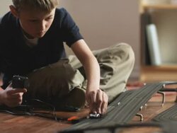 CU TU Boy (10-11) playing with electric slot cars / Orem, Utah, USA. Stock Footage
