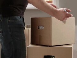 MS PAN Man taping box and writing books on it / Berlin, Germany Stock Footage