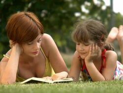 Mother and child reading book Stock Footage