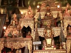 CU PAN Shot of Golden altar filling with small Buddhas and lights / Luang Prabang, Laos Stock Footage