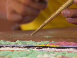 MS TD ZI Man Using small funnel and green sand to creating  temporary piece of  mandala  / Kathmandu, Central, Nepal Stock Footage