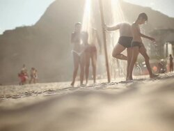 Men and women walking across the beach Stock Footage