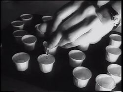 B/W 1962 close up woman's hand using eyedropper to put oral polio vaccine into paper cups / newsreel Stock Footage