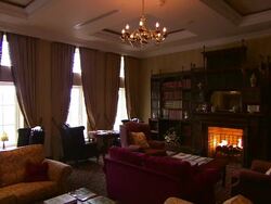 Traditional hotel lounge, old fashioned chairs and roaring fire, Lough Erne, Northern Ireland Stock Footage