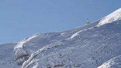 Snowboarder walking on the mountains edge Stock Footage