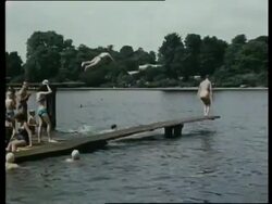 People swimming and relaxing in London park, London, UK, 1963 Stock Footage